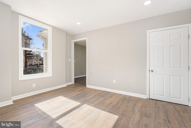 unfurnished bedroom with hardwood / wood-style floors