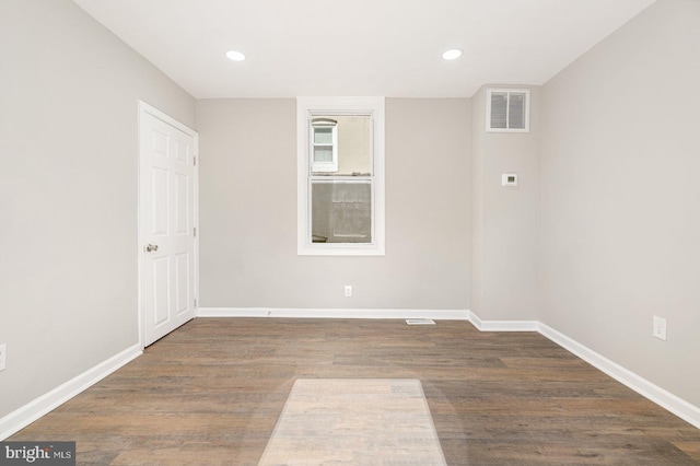 empty room featuring dark hardwood / wood-style flooring