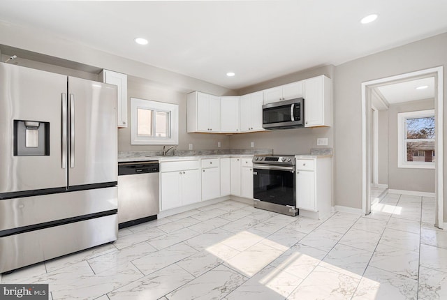 kitchen with white cabinetry, appliances with stainless steel finishes, and sink