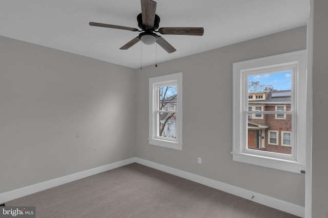 carpeted empty room featuring ceiling fan