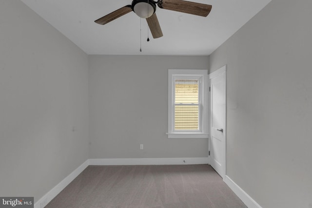 carpeted spare room with ceiling fan