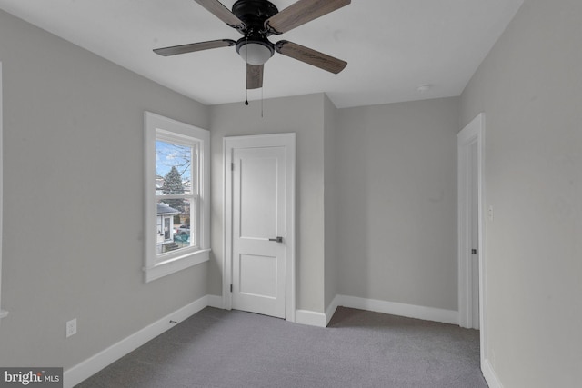 unfurnished bedroom with ceiling fan and carpet flooring