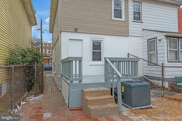 rear view of house with central AC unit