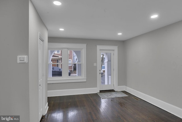 foyer entrance with dark hardwood / wood-style floors