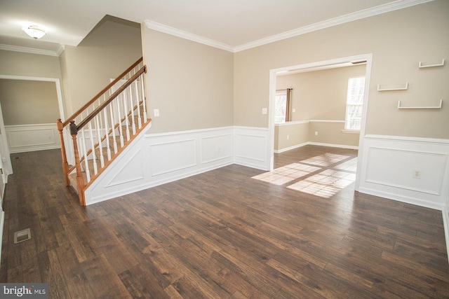 interior space featuring dark wood finished floors, stairway, crown molding, and a wainscoted wall