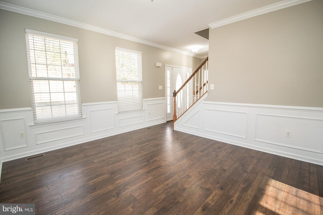 interior space featuring visible vents, crown molding, stairway, a wainscoted wall, and dark wood-style flooring