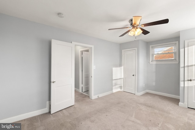 unfurnished bedroom featuring light carpet, ceiling fan, and baseboards