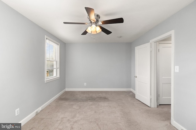 unfurnished bedroom featuring light carpet, ceiling fan, and baseboards