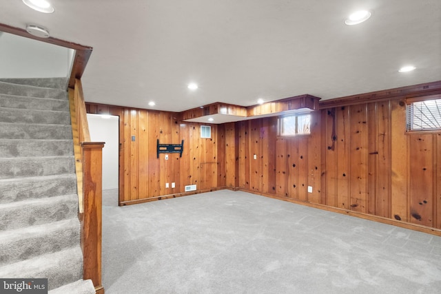 basement featuring recessed lighting, light colored carpet, stairway, and baseboards