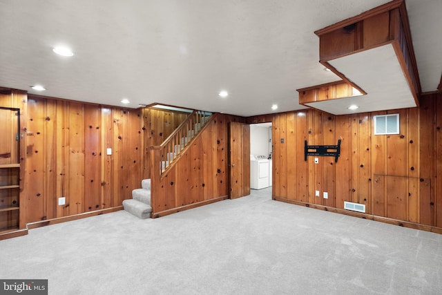 finished basement featuring recessed lighting, light colored carpet, visible vents, washer / dryer, and stairs