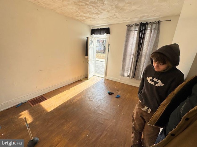 interior space with hardwood / wood-style flooring and a textured ceiling