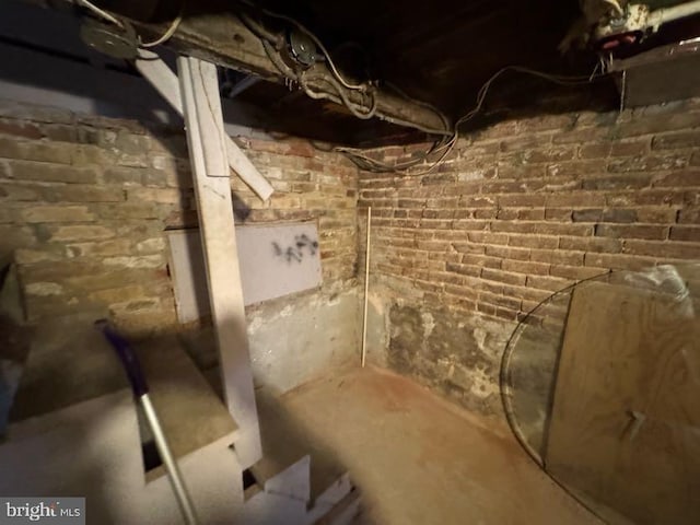 basement featuring brick wall