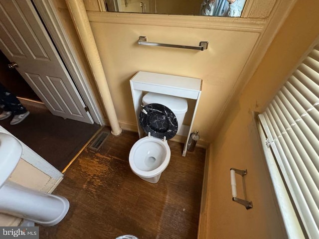 bathroom featuring hardwood / wood-style flooring and toilet