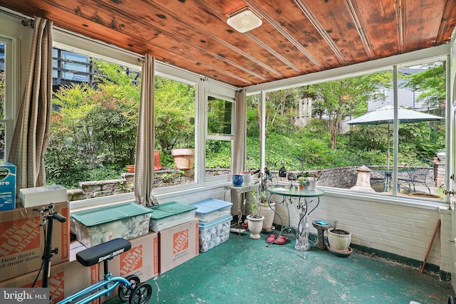 sunroom featuring wood ceiling and a wealth of natural light