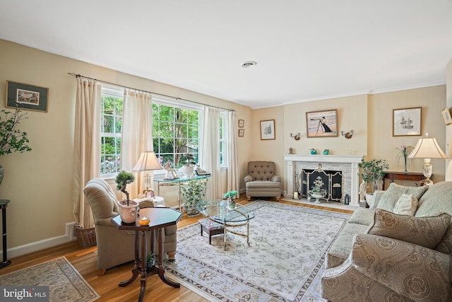 living room with hardwood / wood-style floors and a brick fireplace