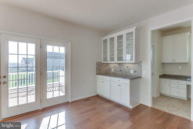 kitchen featuring white cabinetry, a wealth of natural light, and light hardwood / wood-style floors