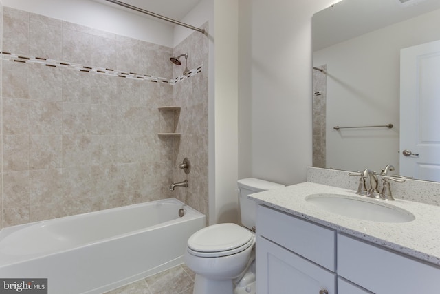 full bathroom with tile patterned floors, toilet, tiled shower / bath combo, and vanity