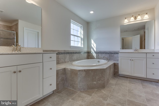 bathroom featuring vanity and plus walk in shower