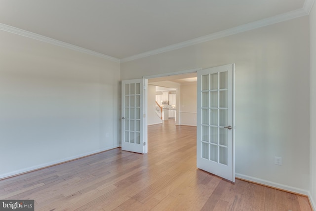 unfurnished room featuring ornamental molding, french doors, and light wood-type flooring