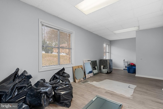 misc room with hardwood / wood-style flooring and a drop ceiling