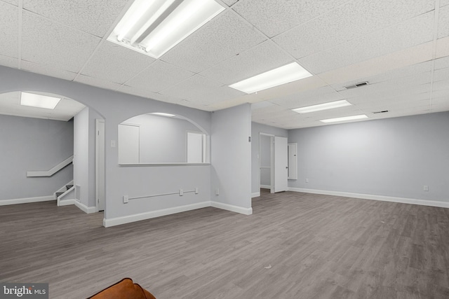 spare room featuring wood-type flooring and a paneled ceiling