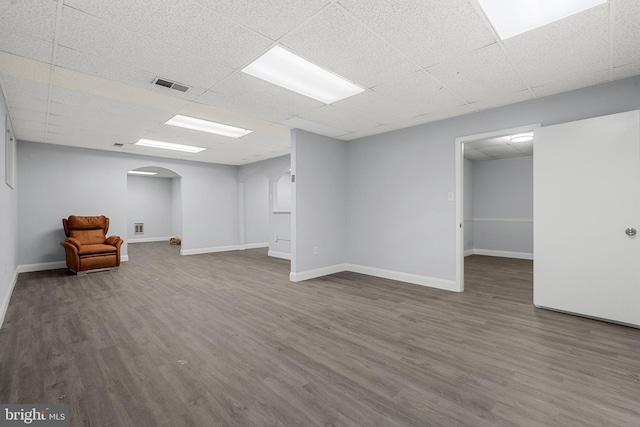 basement with hardwood / wood-style flooring and a paneled ceiling