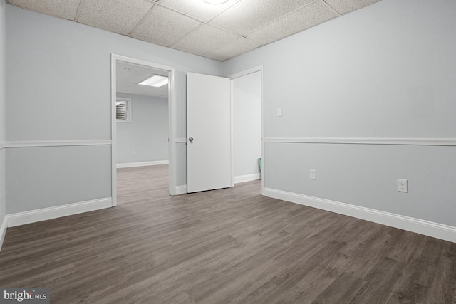 unfurnished room featuring a paneled ceiling and wood-type flooring