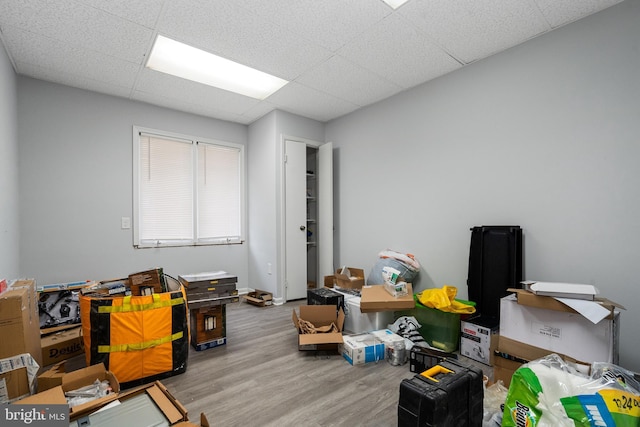 miscellaneous room featuring a drop ceiling and light hardwood / wood-style floors