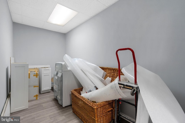 misc room with light hardwood / wood-style floors and a drop ceiling