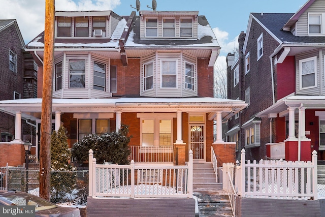 view of front of property featuring covered porch and cooling unit