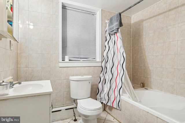 full bathroom with tile patterned floors, shower / bath combo, toilet, tile walls, and vanity