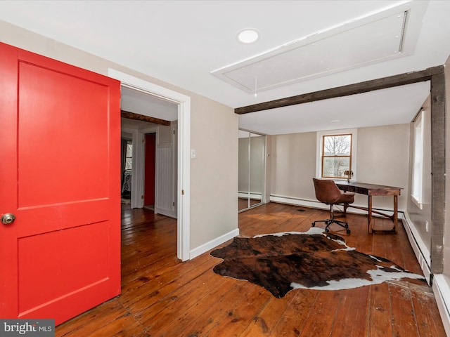 home office with a baseboard radiator and dark hardwood / wood-style floors