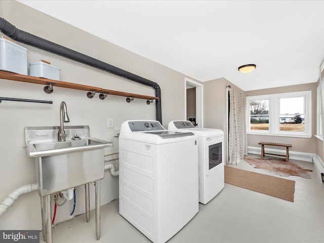 laundry area featuring sink and washer and clothes dryer