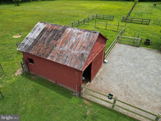 aerial view featuring a rural view, a lawn, and an outdoor structure