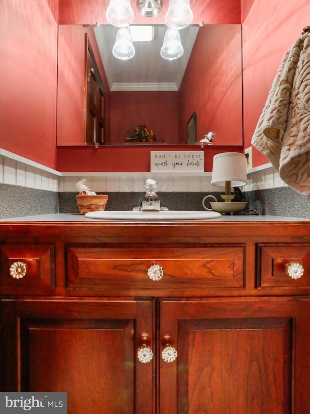 bathroom with ornamental molding and sink