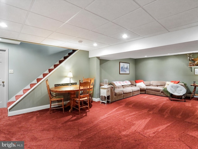 carpeted living room with a paneled ceiling