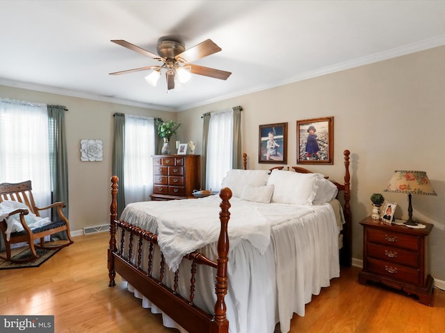 bedroom with crown molding, ceiling fan, and light wood-type flooring