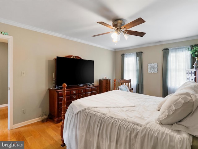 bedroom featuring ornamental molding, ceiling fan, and light hardwood / wood-style floors