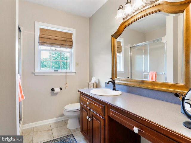 bathroom featuring tile patterned flooring, vanity, a shower with shower door, and toilet