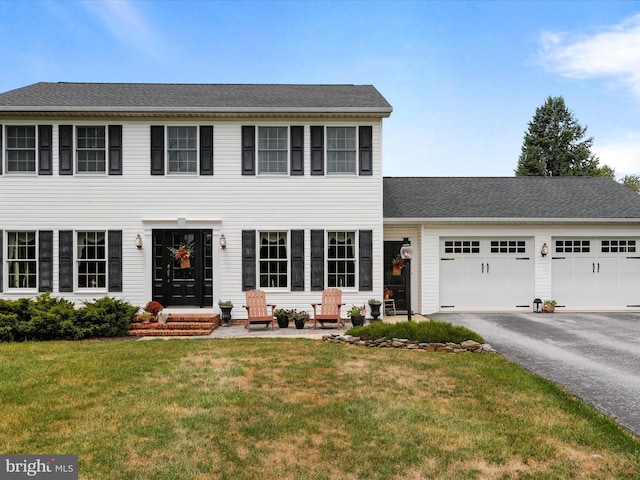 view of front of home featuring a garage and a front yard