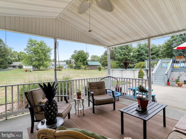 sunroom / solarium featuring ceiling fan and lofted ceiling