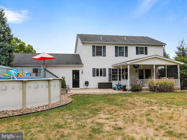 back of property featuring a yard and a patio