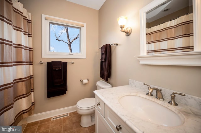 bathroom with vanity, tile patterned flooring, and toilet