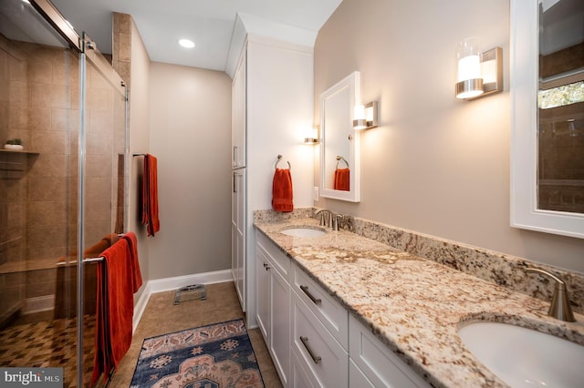 bathroom with vanity, an enclosed shower, and tile patterned flooring