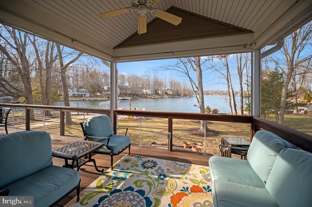 wooden deck featuring a water view and ceiling fan