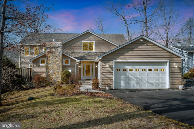 view of front of home featuring a garage and a lawn