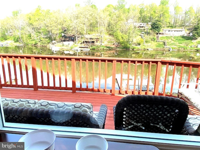 wooden terrace featuring a water view