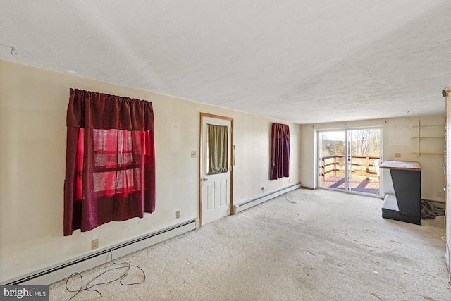 unfurnished living room with baseboard heating, carpet, and a textured ceiling