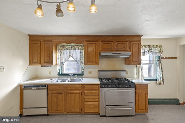 kitchen featuring sink, stainless steel gas range oven, a baseboard radiator, white dishwasher, and backsplash