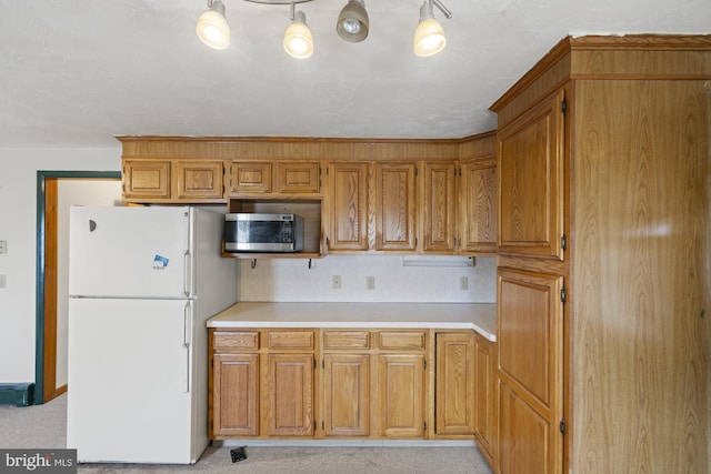 kitchen with white refrigerator and light colored carpet